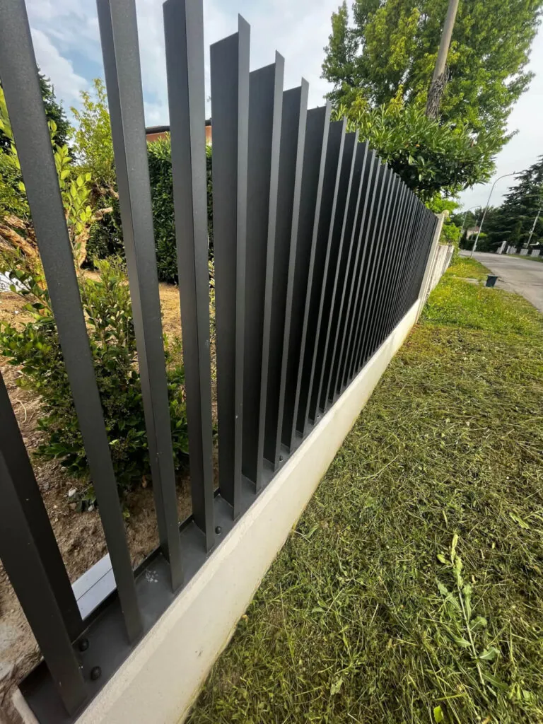 Recinzione metallica modulare per abitazione privata, verniciata in grigio antracite con design a listelli orizzontali inclinati stile persiana (frangivista). Prodotta e installata su misura da Carpenteria 2A, Treviso - foto ringhiere in ferro.
